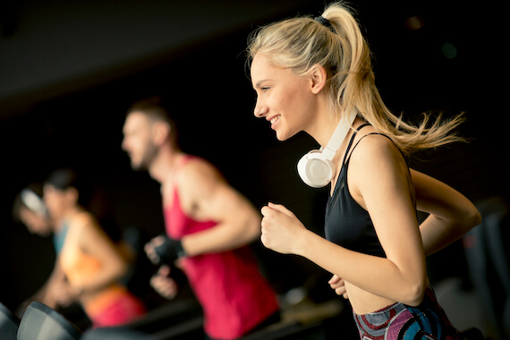 Woman running on fitness center treadmill