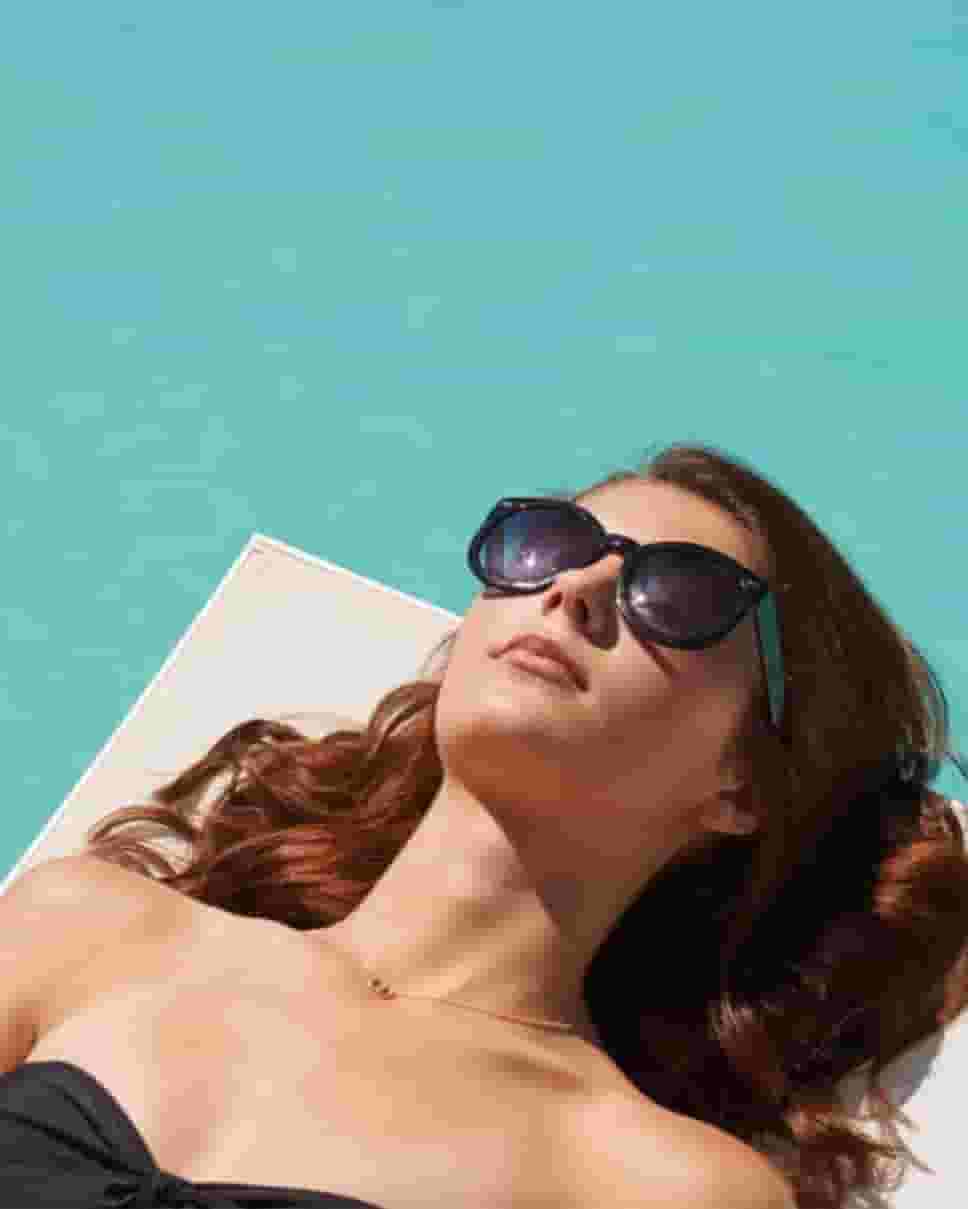 Female student lounging in the Courtyard Pool