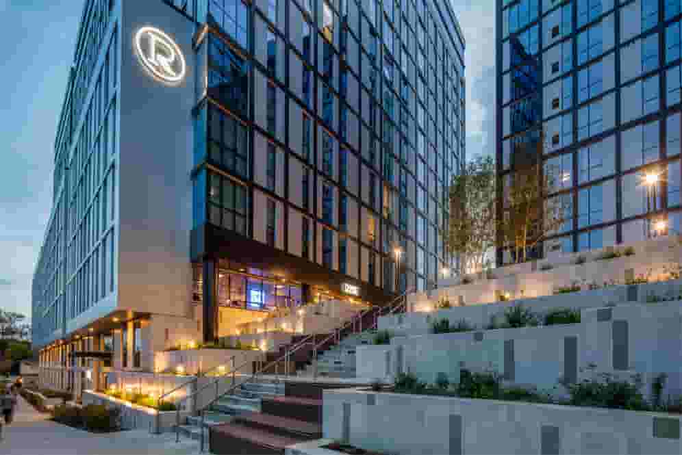 Illuminated step entrance to Rise at dusk