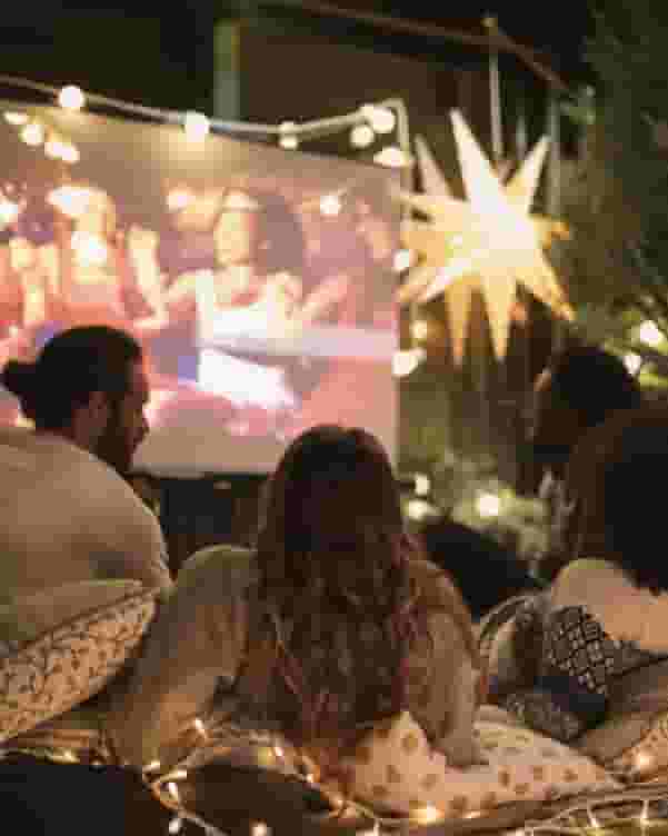 Group of ECU students watching a movie outdoors