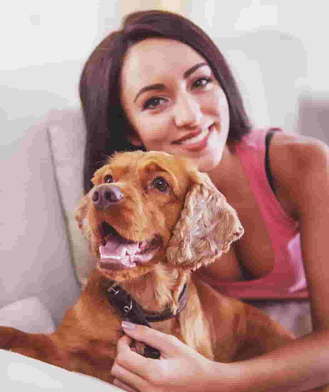 Resident on apartment sofa with her dog by her side