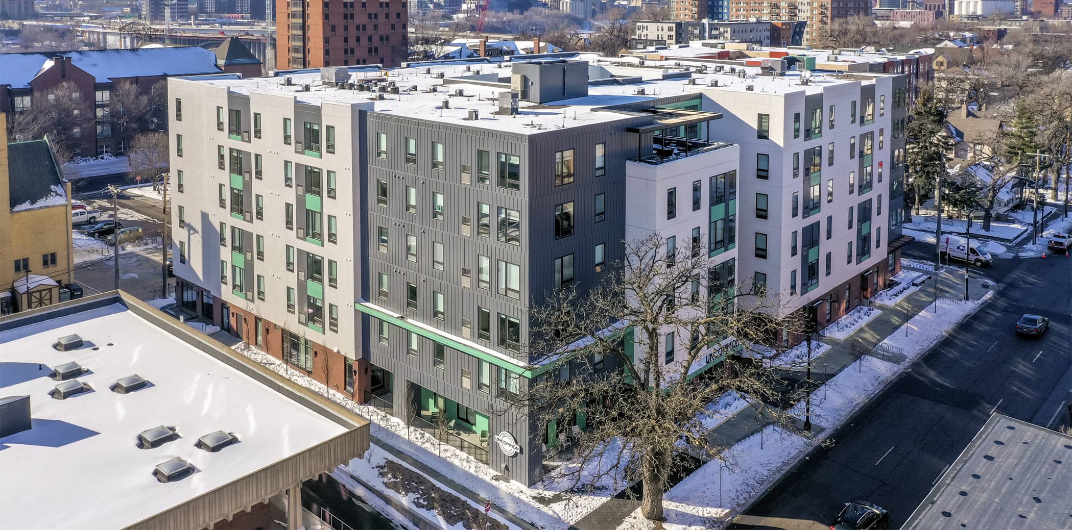 Exterior Aerial View of UNCOMMON Dinkytown with Minneapolis over Horizon