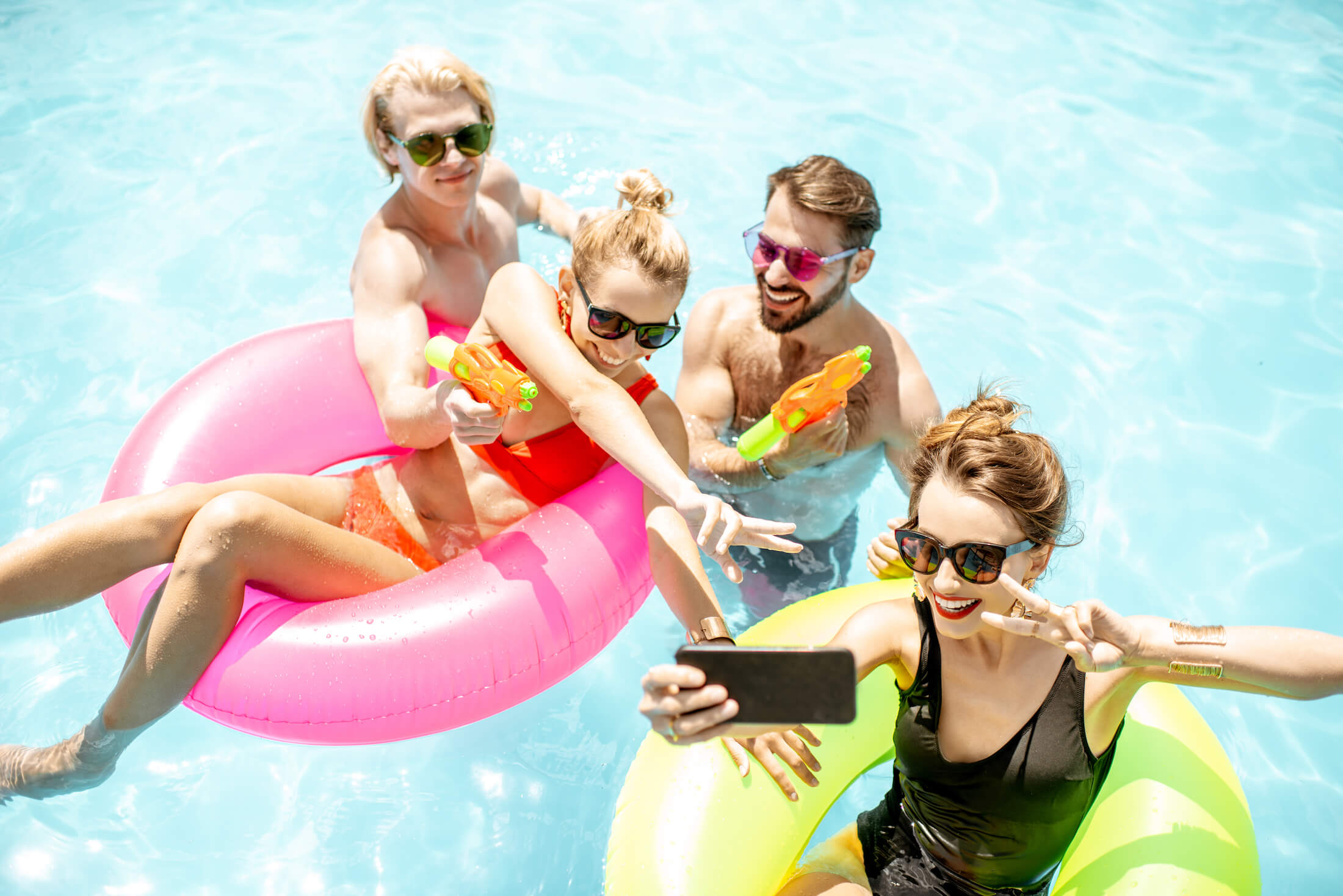 FAU students laughing in University Park pool